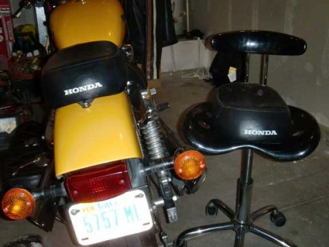 1980 Honda CB750 - Rear view of a motorcycle a yellow fender, black seat with a Honda logo, and an Iowa license plate.