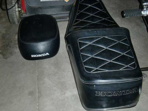1980 Honda CB750 - Two black vinyl motorcycle seats with diamond stitching are shown, both bearing the Honda logo.