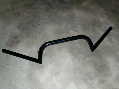 1980 Honda CB750 - Black motorcycle handlebars are shown against a concrete background, likely a replacement part for a motorcycle rebuild.