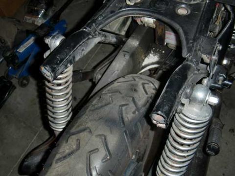 1980 Honda CB750 - Detail of a motorcycle's rear suspension and frame components during a rebuild.
