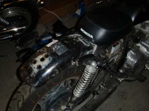 1980 Honda CB750 - A close-up view of a Honda motorcycle's rear section, showing the seat and fender.