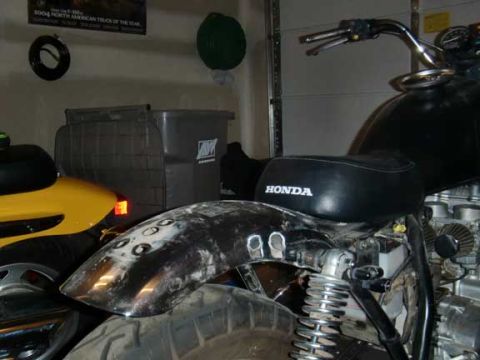 1980 Honda CB750 - A black Honda motorcycle is partially visible, with a focus on its rear fender and seat.
