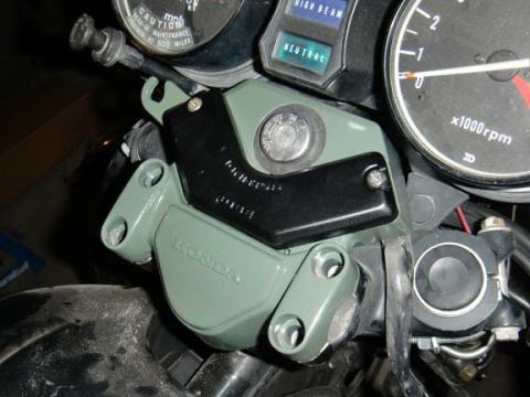 1980 Honda CB750 - Motorcycle dashboard details including gauges and controls, with a visible Honda logo on a component.