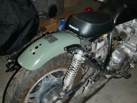 1980 Honda CB750 - The rear fender and seat of a motorcycle are visible, with the "HONDA" logo clearly displayed on the seat.
