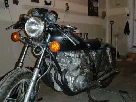 1980 Honda CB750 - Close-up of a motorcycle's engine and front wheel, showing mechanical details.