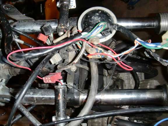 Motorcycle wiring harness with red and green wires connected to a junction