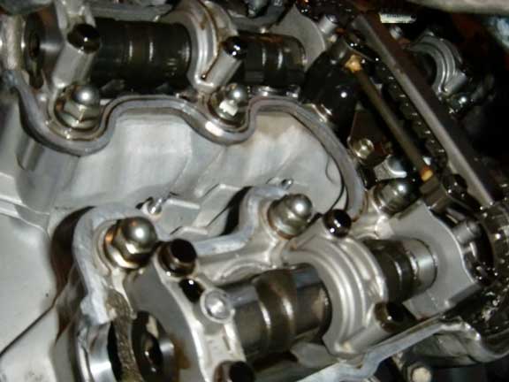Close-up of motorcycle engine valve train with camshafts and timing chain