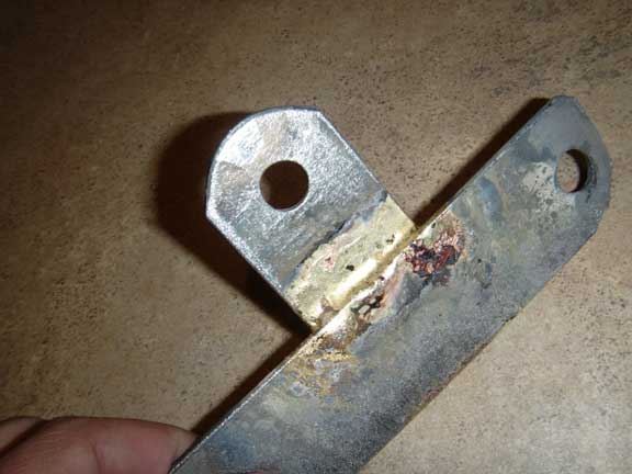 Metal bracket with holes and rust