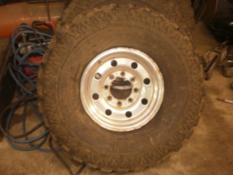 1995 Ford Bronco - A close-up view of a tire and wheel assembly, likely a replacement part.