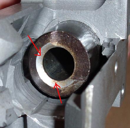 2000 Ford Crown Victoria - This image shows a close-up view of a worn metal component, with red arrows highlighting areas of damage.