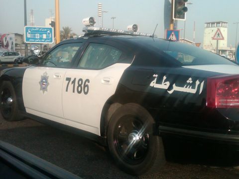 2010 Ford Falcon - Side view of a police car with Arabic writing and a numerical identifier.