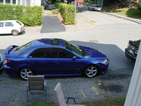 2003 Mazda 6 - Blue 2003 Mazda 6 sedan parked on a residential street.