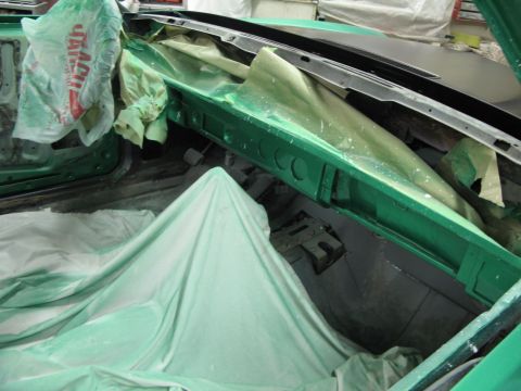 1971 Ford Ranchero - Interior of a vehicle undergoing repair, with green protective coverings obscuring most of the components.