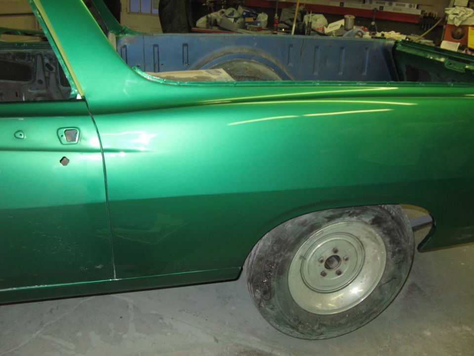 Green 1971 Ford Ranchero side view, showing door, rear quarter panel, and wheel