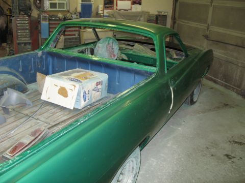 1971 Ford Ranchero - A green pickup truck is undergoing restoration, with its bed and cab visible.