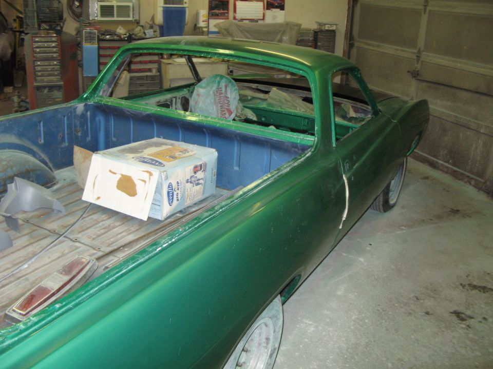 Green pickup truck bed with a box and a taillight, viewed from the passenger side rear