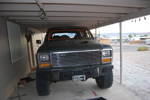 1982 Ford Bronco - This SUV, likely from the early 1980s, features a prominent chrome grille, a front winch, and an interior roll cage.