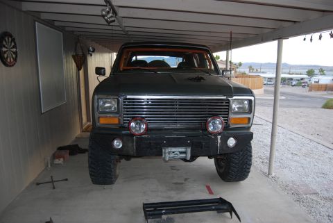 1982 Ford Bronco - Front view of a modified Ford Bronco, likely from the early 1980s, parked in a covered area.