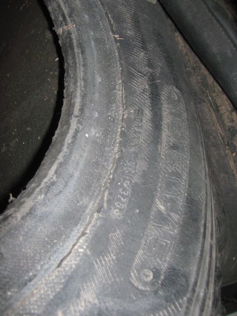 1968 Ford Mustang - A close-up view of a tire shows wear and molded text on its sidewall.