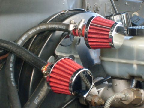 1986 Ford Bronco - Close-up of engine bay components, two red air filters and a marked hose.