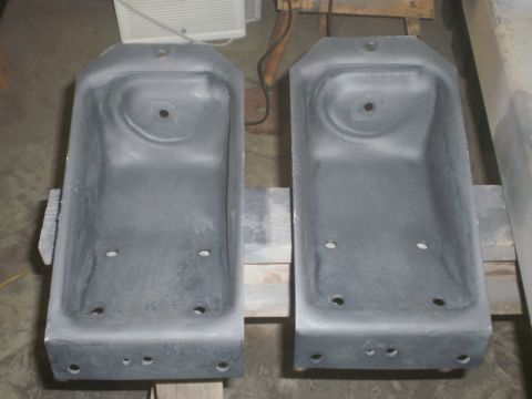 1995 Ford Bronco - A pair of metal brackets, likely for a vehicle, are shown up close.