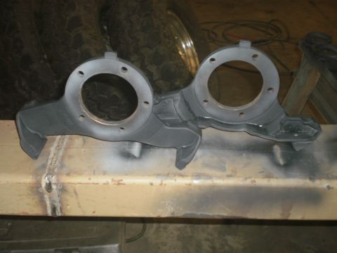 1995 Ford Bronco - Two painted suspension knuckles are shown, likely for a vehicle's front axle.