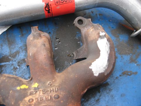 1981 Ford Bronco - Close-up of an exhaust manifold part, showing the part number E7TE-HD 9B110 and some repair work.