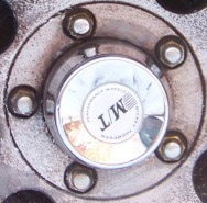 1990 Ford Bronco - Close-up of a wheel center cap with M/T Micro-Trak branding.