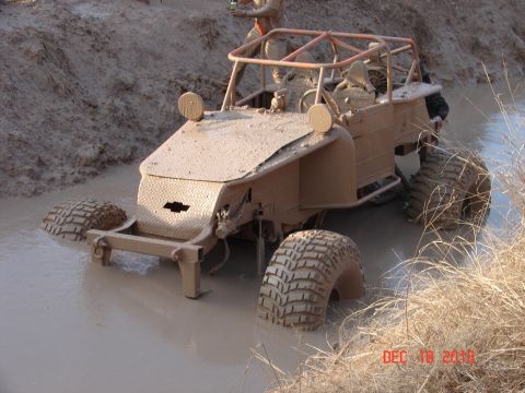 1987 Ford Bronco - This off-road buggy is stuck in the mud, with a Chevrolet emblem visible on the front.