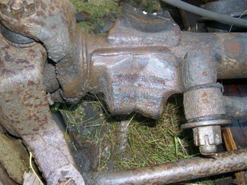 1982 Ford Bronco - Close-up of heavily rusted axle components, with "SUPERMOTORS" text visible at the bottom.