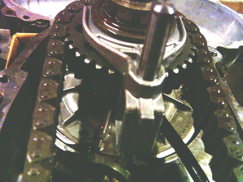 Close-up of engine timing chain and gears, some metal components visible
