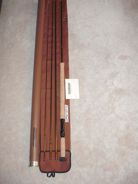 1990 Ford Bronco - A Sage fly fishing rod is shown with its protective case and accompanying paperwork.