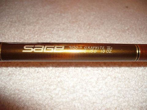 1990 Ford Bronco - Close-up of a Sage fishing rod, identified as a 9150-4 Graphite IIIe model.