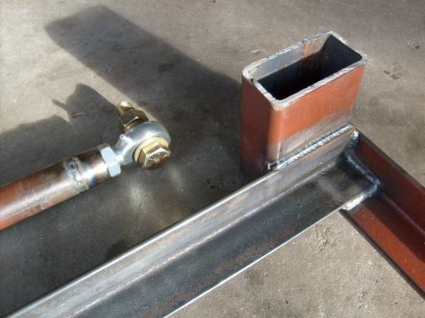 1986 Ford Bronco - Close-up of a metal frame with a rod end fitting, showing welding details.