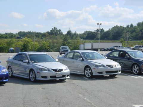 2003 Mazda 6 - Two silver 2003 Mazda 6 sedans are parked in a lot on a sunny day.