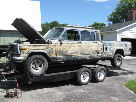 1986 Jeep Grand Wagoneer - This 1986 Jeep Grand Wagoneer pickup truck is on a trailer with its hood open.