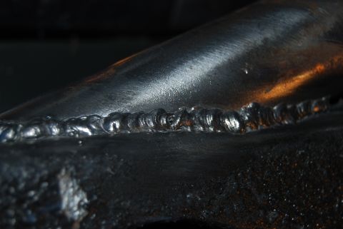 1982 Ford Bronco - Close-up view of a welded metal joint on a component.