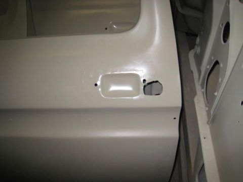 1976 Ford F-250 - The interior of a vehicle's door and frame are shown, both in primer before painting.