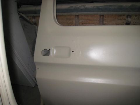 1976 Ford F-250 - Close-up view of the door handle and lock mechanism on a 1976 Ford F-250, likely during a restoration or build process.