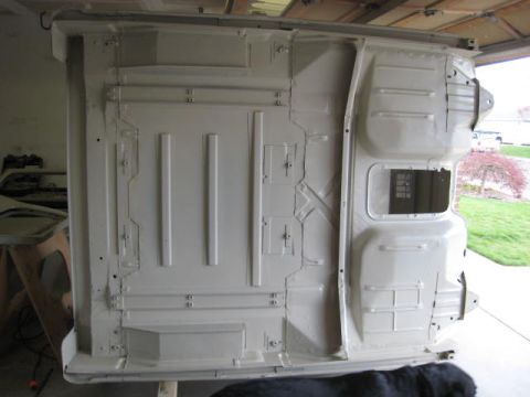 1976 Ford F-250 - The underside of a white 1976 Ford F-250 truck bed is shown, likely during a restoration or build process.