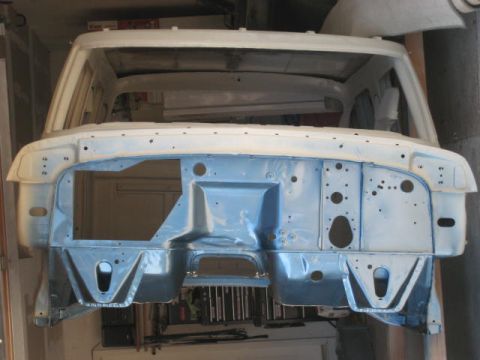 1976 Ford F-250 - The front end of a truck cab, stripped and prepped for restoration, is shown in this image.