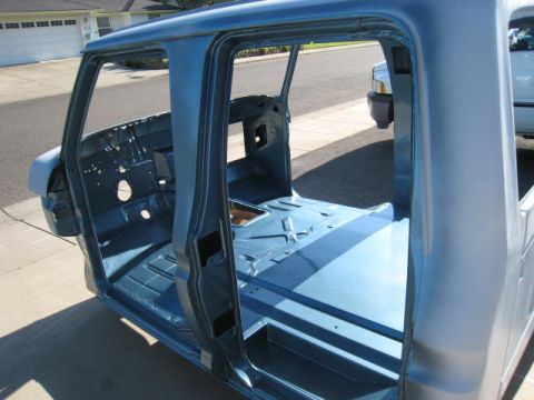 1976 Ford F-250 - The stripped-down interior of a 1976 Ford F-250 cab, ready for restoration work.