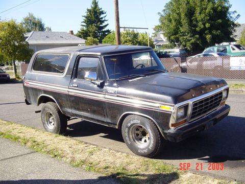 1979 Ford Bronco - This Ford Bronco is parked curbside on a sunny day, showing its front and side profile.