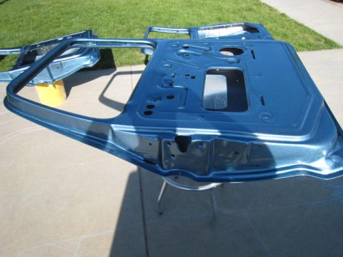 1976 Ford F-250 - Two blue painted truck doors are shown outdoors, likely during a restoration or painting process.