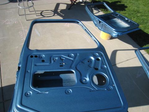 1976 Ford F-250 - Car doors and frame are prepped and painted blue outdoors.