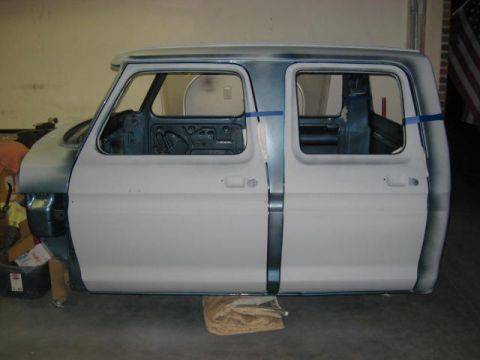 1976 Ford F-250 - This 1976 Ford F-250 crew cab is undergoing restoration, showing its bare metal and primer finish from a side perspective.