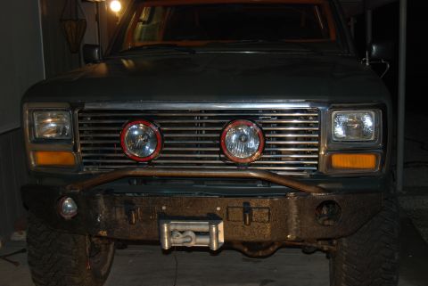 1982 Ford Bronco - Front view of a 1982 Ford Bronco an aftermarket grille, spotlights, and a winch bumper.