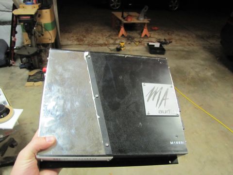 1993 Ford F-250 - A car amplifier with the MA audio logo is held in a hand, with a workshop in the background.