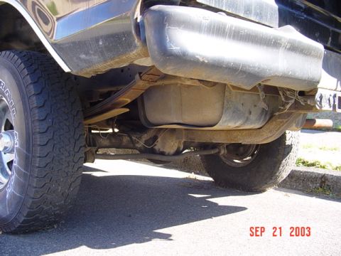 1979 Ford Bronco - The rear undercarriage of a vehicle, including the fuel tank and suspension components, is visible.