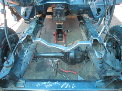 1976 Ford F-250 - The underside of a vehicle is shown with the frame, suspension, and drivetrain components visible.